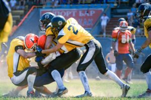 football defensive linemen hustling to make tackle