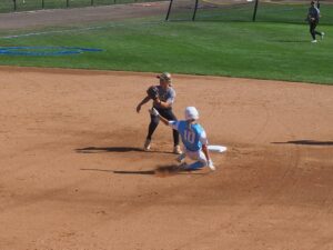 softball shortstop covers second base on steal attempt