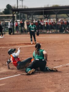 softball third baseman tagging runner