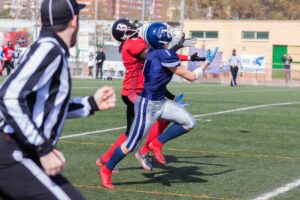 football wide receiver catching the ball