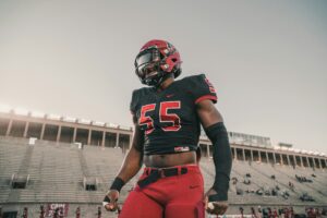 football player standing in stadium during warmups