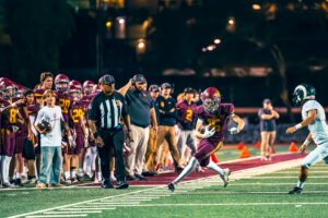 football player staying in bounds on sideline