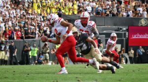 football quarterback evading tackle and running