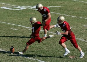 american football kicker kicking off