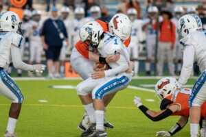 football player getting hit